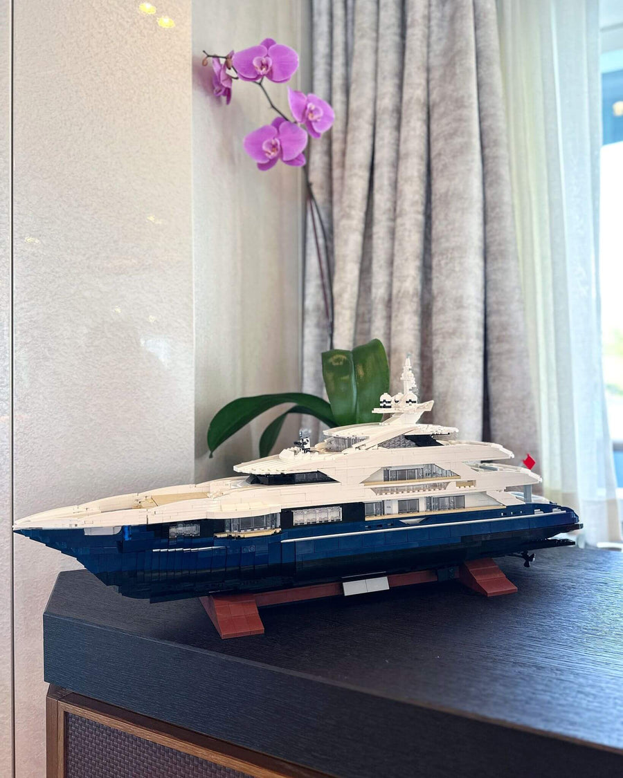 Custom brick model of a yacht displayed on a sideboard