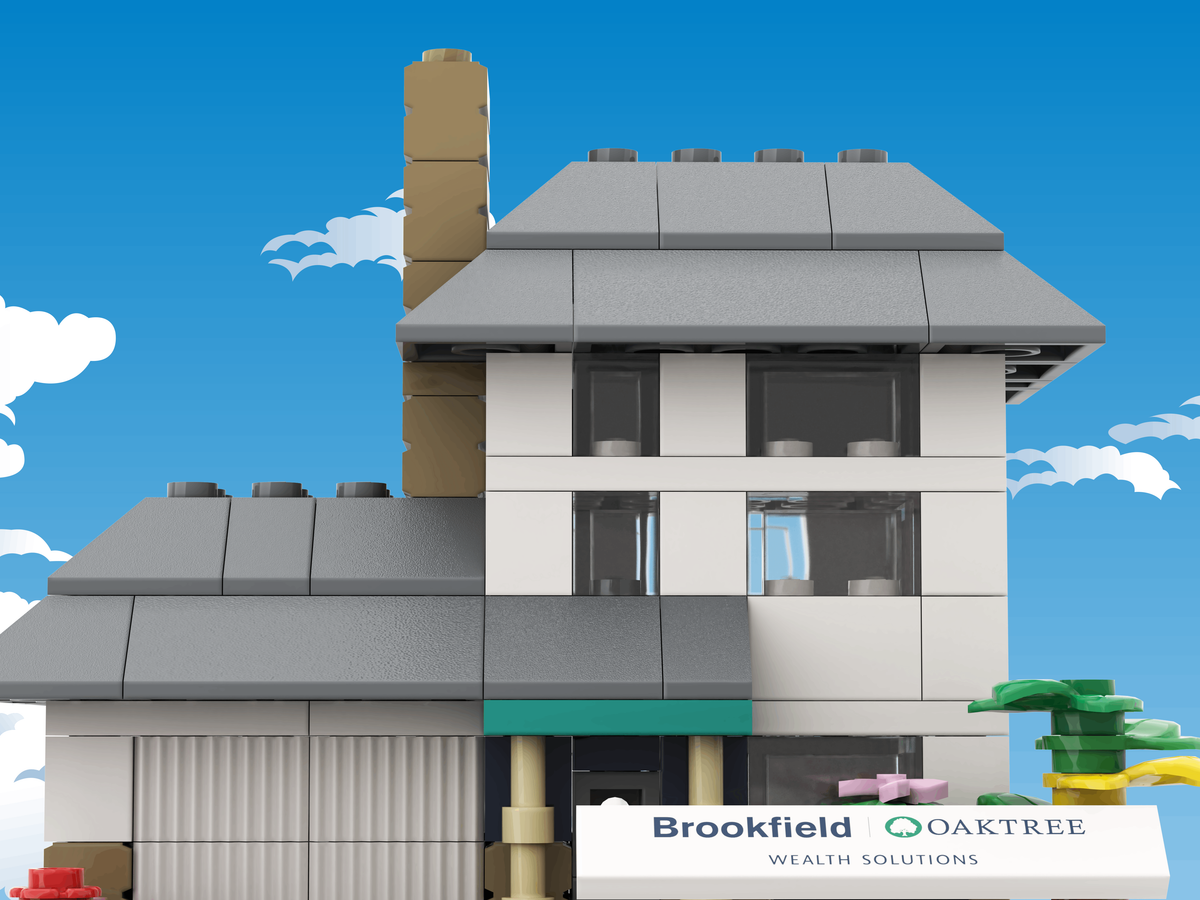 Model house made of building blocks with a clear blue sky background