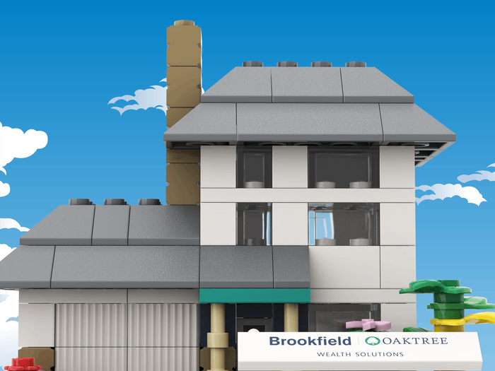 Model house made of building blocks with a clear blue sky background